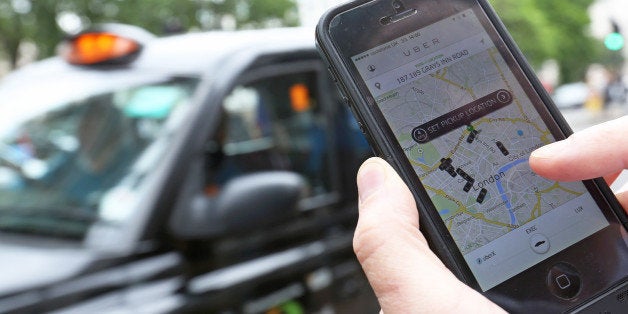 A user scans for an available vehicle using the Uber Technologies Inc.'s app on an Apple Inc. iPhone 5 smartphone in this arr