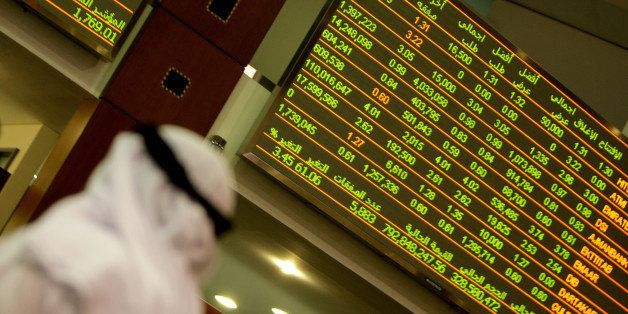 An Emirati man follows the market activity at the Dubai stock market on March 25, 2010. Dubai's main stock market index was up 4.5 percent by midday as Dubai World proposed to repay its creditors in full by issuing two tranches of new debt maturing in five and eight years, after months of talks on restructuring sovereign liabilities that had rattled world markets. AFP PHOTO/KARIM SAHIB (Photo credit should read KARIM SAHIB/AFP/Getty Images)
