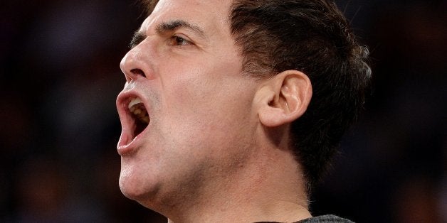 Dallas Mavericks owner Mark Cuban stands behind the Dallas bench in the opening minutes against the New York Knicks during their NBA game February 24, 2014 at Madison Square Garden in New York. The Mavericks won, 110-108. AFP PHOTO/Stan HONDA (Photo credit should read STAN HONDA/AFP/Getty Images)