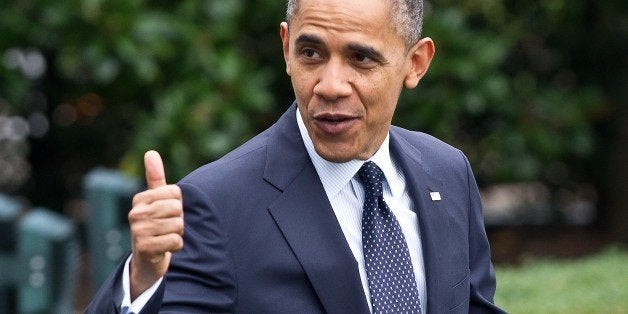 US President Barack Obama gives the thumbs up as he walks out of the White House in Washington on October 7, 2012 before depa