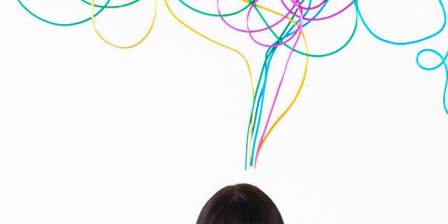 woman smiling with jumbled colored wire above head