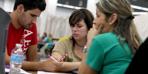 MIAMI, FL - MARCH 31: Jose Villanueva (L) and Doraisy Avila sit with Maria Gabriela an agent from Sunshine Life and Health Advisors as they discuss pricing plans available from the Affordable Care Act at a store setup in the Mall of Americas on March 31, 2014 in Miami, Florida. Today is the last day for the first yearly sign-up period and Sunshine Life and Health saw a wait of four hours or more for people to see a health insurance advisor. (Photo by Joe Raedle/Getty Images)