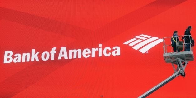 Workers fix a large electronic billboard featuring an advertisement for Bank of America on Times Square in New York, February 19, 2014. AFP PHOTO/Emmanuel Dunand (Photo credit should read EMMANUEL DUNAND/AFP/Getty Images)