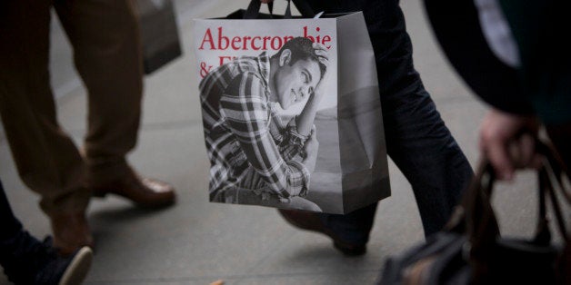 A customer carries an Abercrombie & Fitch Co. shopping bag from one of the company's locations in New York, U.S., on Wednesda