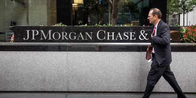 NEW YORK, NY - AUGUST 12: A man walks past JP Morgan Chase's corporate headquarters on August 12, 2014 in New York City. U.S. banks announced second quarter profits of more than $40 billion, showing strong signs of a recovering economy. (Photo by Andrew Burton/Getty Images)