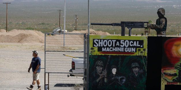 A man closes off an entrance to the Last Stop outdoor shooting range Wednesday, Aug. 27, 2014, in White Hills, Ariz. Gun range instructor Charles Vacca was accidentally killed Monday, Aug. 25, 2014 at the range by a 9-year-old with an Uzi submachine gun. (AP Photo/John Locher)