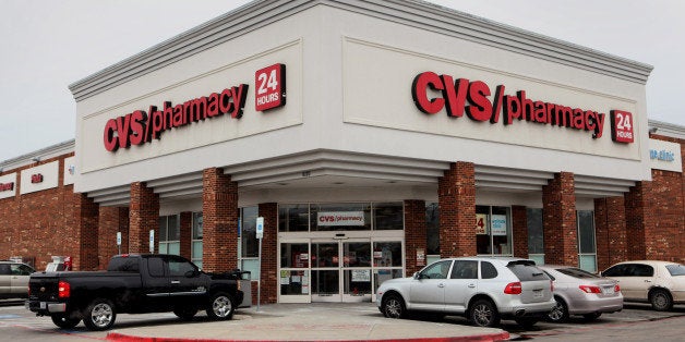 Cars sit parked outside of a CVS Caremark Corp. store in Dallas, Texas, U.S., on Friday, Feb. 7, 2014. CVS Caremark Corp. is
