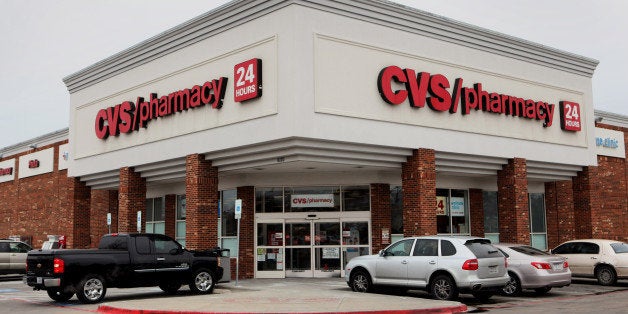 Cars sit parked outside of a CVS Caremark Corp. store in Dallas, Texas, U.S., on Friday, Feb. 7, 2014. CVS Caremark Corp. is scheduled to release earnings figures on Feb. 11. Photographer: Ben Torres/Bloomberg via Getty Images