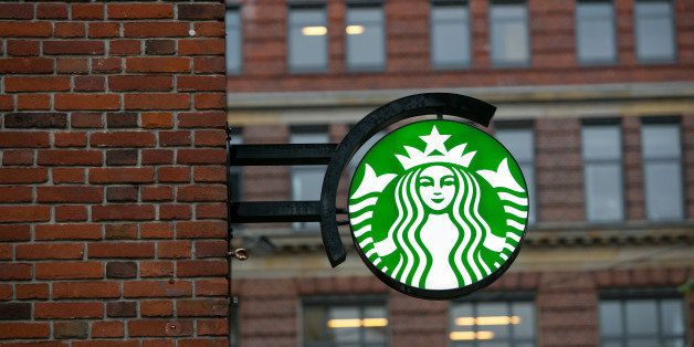 A Starbucks Corp. logo hangs outside one of the company's coffee shops in Bremen, Germany, on Tuesday, May 27, 2014. Germany's economic growth in the first quarter was driven exclusively by internal demand, highlighting the uneven nature of the euro area's recovery. Photographer: Krisztian Bocsi/Bloomberg via Getty Images