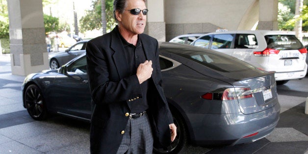 Texas Gov. Rick Perry walks over to talk to reporters after driving up in a Tesla Motors Type S electric car in Sacramento, Calif., Tuesday, June 10, 2014. Perry, the former and potential 2016 Republican presidential candidate, arrived at the meeting with statewide GOP lawmakers and officials across the street from the state Capitol. He is trying to persuade Tesla Motors, based in Palo Alto, to build a $5 billion battery plant in Texas. (AP Photo/Rich Pedroncelli)