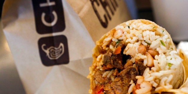 A steak burrito is arranged for a photograph with a drink and bags of chips at a Chipotle Mexican Grill Inc. restaurant in Ho