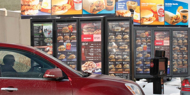 A patron looks at the menu at McDonald's in Williamsville, N.Y., Monday, Jan. 26, 2009. As most restaurant companies prepare