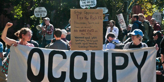 Protesters representing the Occupy Wall Street movement, rally on Tuesday, Sept. 17, 2013, in Washington Square Park in New York. It has been two years since protesters first pitched tents in lower Manhattan, sparking the movement against corporate greed known as Occupy Wall Street. (AP Photo/Bebeto Matthews)