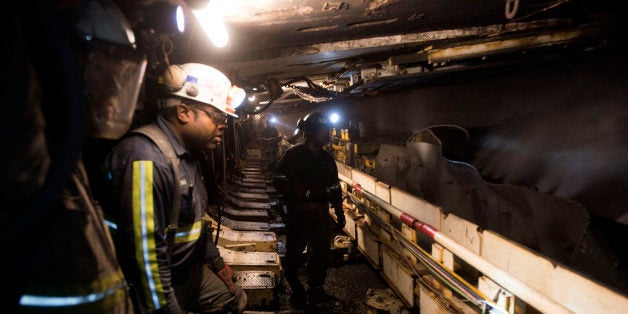 Coal miners watch as a carbide-tipped shearer scrapes coal from the wall during longwall mining operations at the Consol Energy Bailey Mine in Wind Ridge, Pennsylvania, U.S., on Tuesday, May 14, 2013. Coalâs prospects are improving after its share of U.S. power generation fell last year to 34 percent, the lowest since at least 1973, Energy Department data show. Hotter temperatures this summer that prompt American households to use more air conditioning will boost demand for coal and the railroads that ship it. Photographer: Ty Wright/Bloomberg via Getty Images