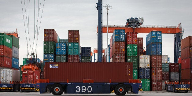 Automated guided vehicles (AGV) transport shipping containers as gantry cranes operate on the dock at the Euromax Terminal in the Port of Rotterdam in Rotterdam, Netherlands, on Wednesday, Aug. 6, 2014. Russia plans to ban the import of all U.S. agricultural products, including poultry, as well as all fruit and vegetable imports from the European Union, according to a report in RIA Novosti citing Alexey Alekseenko, spokesman for Russian food safety watchdog Rosselkhoznadzor. Photographer: Jasper Juinen/Bloomberg via Getty Images