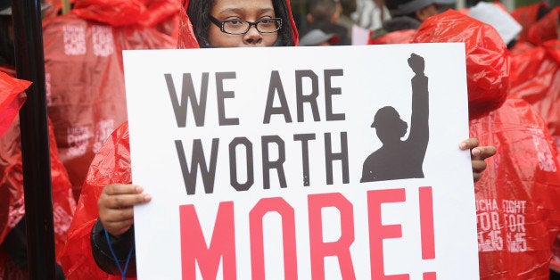 CHICAGO, IL - MAY 15: Fast food workers and activists demonstrate outside McDonald's downtown flagship restaurant on May 15, 2014 in Chicago, Illinois. The demonstration was one of several nationwide calling for wages of $15 per hour and better working conditions for fast food workers. (Photo by Scott Olson/Getty Images)