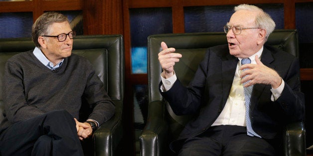 Berkshire Hathaway Chairman and CEO Warren Buffett, right, gestures during an interview with Liz Claman on the Fox Business Network in Omaha, Neb., Monday, May 5, 2014, with Berkshire board member and Microsoft co-founder Bill Gates, left. The annual Berkshire Hathaway shareholders meeting concluded the previous weekend. (AP Photo/Nati Harnik)