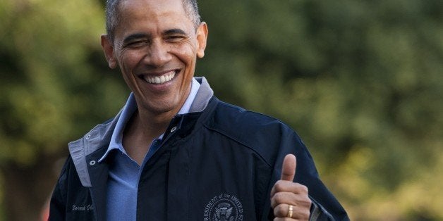 US President Barack Obama gives a thumbs-up as he walks from Marine One upon arrival on the South Lawn of the White House in