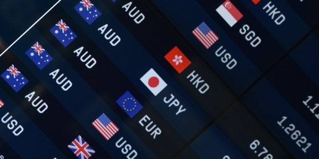 Currency prices are seen on display at a bank on a street in Sydney on October 7, 2014. The Australian dollar hit a four-year-low of 86.43 US cents in New York last week as Australia's economy struggles to transition away from resources-led growth following an unprecedented boom in mining investment that is expected to fall-off sharply over the next year.AFP PHOTO/Peter PARKS (Photo credit should read PETER PARKS/AFP/Getty Images)