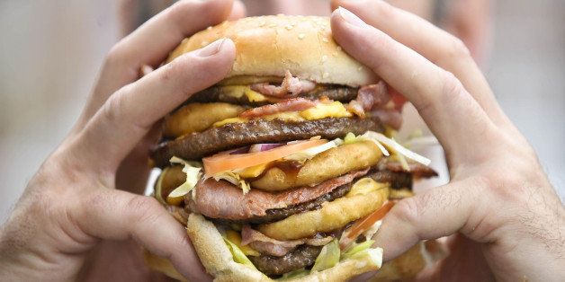 Karl Ford, aged 40, from Shirehampton, Bristol, who is a burger chef and creator of the 'Super Scooby' burger, Britain's largest and most fattening burger with an artery-busting 2,645 calories, holds his super sandwich.