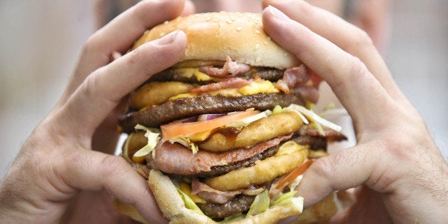 Karl Ford, aged 40, from Shirehampton, Bristol, who is a burger chef and creator of the 'Super Scooby' burger, Britain's largest and most fattening burger with an artery-busting 2,645 calories, holds his super sandwich.