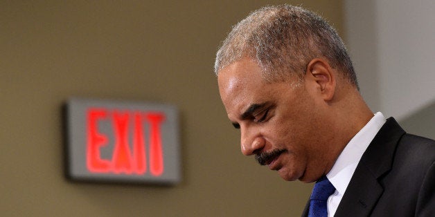 Outgoing Attorney General Eric Holder pauses while speaking at the Voting Rights Brain Trust event, Friday, Sept. 26, 2014, d