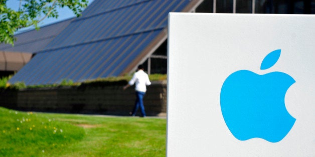 An apple logo sit on a sign at Apple Inc.'s campus in Cork, Ireland, on Tuesday, June 4, 2013. Speaking to lawmakers in Dubli