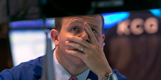 Specialist jason Notter works at his post on the floor of the New York Stock Exchange, near the close of trading, Friday, Oct. 10, 2014. U.S. stocks closed out a turbulent week with another loss, giving the market its worst week since May 2012. (AP Photo/Richard Drew)