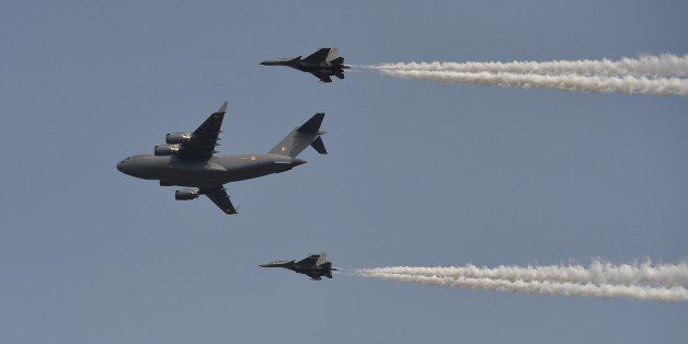 An Indian Air Force C-17 (C) aircraft and two fighter jets perform a flypast during the Air Force Day parade at the Hindon Air Force Station in Ghaziabad, on the outskirts of New Delhi on October 8, 2014. The Indian Air Force celebrated the 82nd Air Force Day. AFP PHOTO / CHANDAN KHANNA (Photo credit should read Chandan Khanna/AFP/Getty Images)