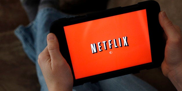FILE - In this Friday, Jan. 17, 2014 file photo, a person displays Netflix on a tablet in North Andover, Mass. Netflix is giv