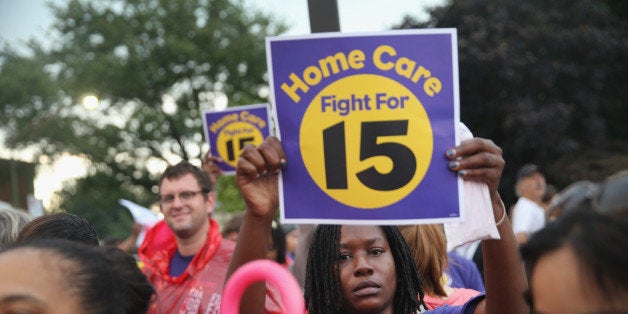 CHICAGO, IL - SEPTEMBER 04: Demonstrators protest for an increase in wages for fast food and home care workers during the morning rush hour on September 4, 2014 in Chicago, Illinois. Nineteen protestors were arrested at the demonstration after they staged a sit-in in the middle of 87th Street. The demonstration was one of many held nationwide in a push to increase wages to $15-per-hour for the workers. (Photo by Scott Olson/Getty Images)