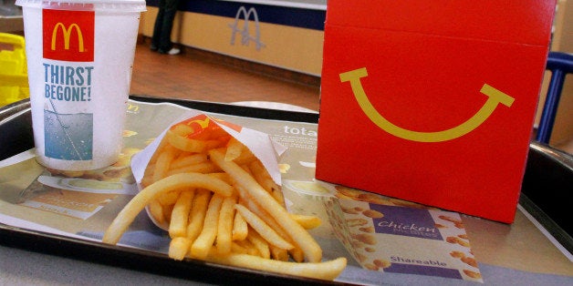 In this Jan. 20, 2012 photo, the McDonald's logo and a Happy Meal box with french fries and a drink are posed at McDonald's, in Springfield, Ill. McDonaldâs Corp. saw net income jump by 11 percent in the fourth quarter, as the fast-food giant continued to attract budget-conscious customers with low prices. (AP Photo/Seth Perlman)