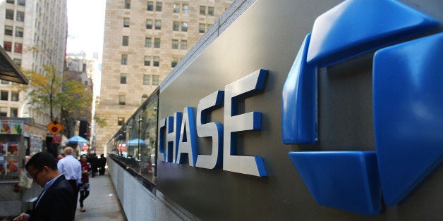 NEW YORK, NY - OCTOBER 14: People walk by One Chase Plaza in lower Manhattan on October 14, 2014 in New York City. JPMorgan Chase, the nation's largest bank, reported third-quarter net income of $5.6 billion, or $1.36 per share, returning the bank to third quarter profitability. (Photo by Spencer Platt/Getty Images)