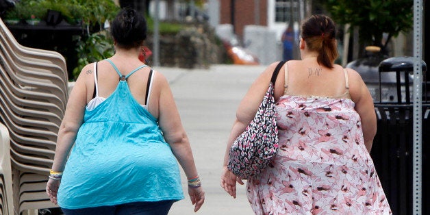 In this June 17, 2013 photo, two women cross the street in Barre, Vt. In its biggest policy change on weight and health to date, the American Medical Association has recognized obesity as a disease. (AP Photo/Toby Talbot)