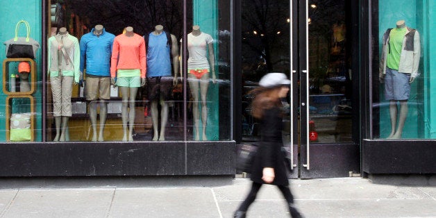 FILE - In this Tuesday, March 19, 2013, file photo, a woman walks past the Lululemon Athletica store at Union Square in New Y