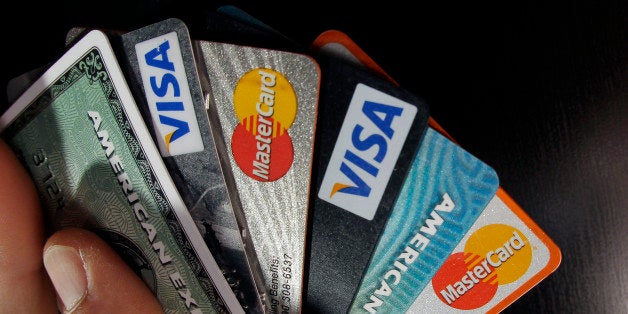 FILE - In this March 5, 2012 file photo, consumer credit cards are posed in North Andover, Mass. The Federal Reserve reports
