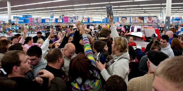 Shoppers vie for copies of video games at a Black Friday sale at a Wal-Mart Stores Inc. store in Mentor, Ohio, U.S., on Thursday, Nov. 24, 2011. Retailers are pouring on the discounts to attract consumers grappling with 9 percent unemployment and a slower U.S. economic expansion than previously estimated. Photographer: Daniel Acker/Bloomberg via Getty Images