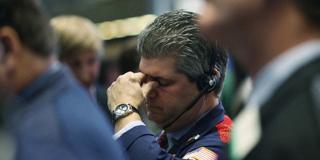 NEW YORK, NY - NOVEMBER 18: Traders work on the floor of the New York Stock Exchange (NYSE) on November 18, 2014 in New York City. The Dow was up in morning trading on news that Japanese government will the measures to stimulate the economy out of recession. (Photo by Spencer Platt/Getty Images)