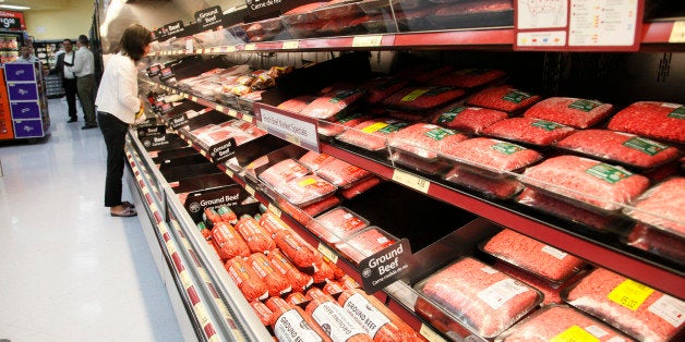 Consumers shop for meat products at the new Walmart Neighborhood Market, opening its 34,000 square foot store in the Chinatown district of Los Angeles Thursday, Sept. 19, 2013. (AP Photo/Nick Ut)