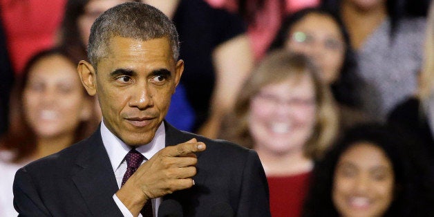 President Barack Obama gestures towards the crowd as they respond to his words while he speaks about the economy after participating in a roundtable discussion with working parents, small business owners, students and faculty, Friday, Oct. 31, 2014, at Rhode Island College in Providence, R.I. Obama wants women to know what his administration is doing to help them succeed. Four days before midterm elections in which Obama's fellow Democrats need a big turnout from female voters, Obama spoke in Rhode Island on growth in the U.S. economy and administration policies directed at women. (AP Photo/Stephan Savoia)