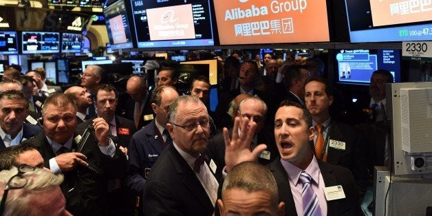 Traders wait for Chinese online retail giant Alibaba's stock to go live on the floor at the New York Stock Exchange in New York on September 19, 2014. A buying frenzy sent Alibaba shares sharply higher Friday as the Chinese online giant made its historic Wall Street trading debut. In early trades after the record public share offering, Alibaba leapt from an opening price of $68 to nearly $100 and, while it dropped back, was still up some 38 percent at $94.08 after 10 minutes. AFP PHOTO/Jewel Samad (Photo credit should read JEWEL SAMAD/AFP/Getty Images)