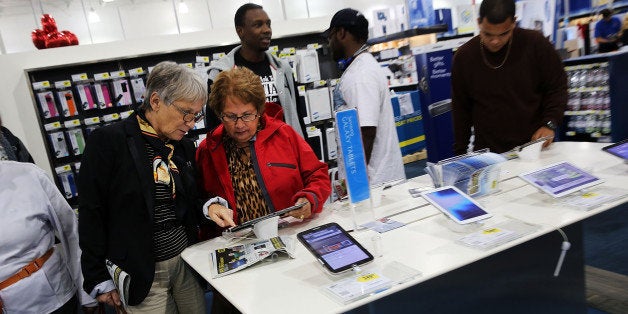 NAPLES, FL - NOVEMBER 29: Black Friday shoppers looks for deals at a Best Buy store which opened its doors at 6pm on Thanksgiving Day this year on November 29, 2013 in Naples, Florida. One of the busiest days in the calendar for retailers, over a dozen US stores opened their doors to shoppers one day ahead of the famed-Black Friday shopping day. (Photo by Spencer Platt/Getty Images)