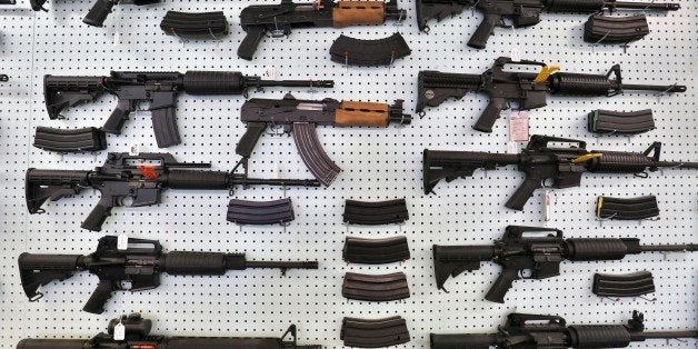 In this July 20, 2014 photo, guns are displayed for sale at Dragonman's, an arms seller east of Colorado Springs, Colo. When Colorado lawmakers expanded background checks on firearms last year, they were expecting a huge increase. But the actual number the first 12 months of the law is far lower than projected, according to an analysis of state data by The Associated Press. (AP Photo/Brennan Linsley)