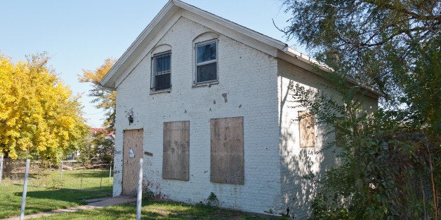 10057 S. Michigan Avenue, on the main street of Roseland, is a vacant single-family home, one of the many scars of the foreclosure epidemic in this part of town. Tax records indicate that it was built in 1921, although the style seems older than that. The front part appears to be a cottage, but additions ramble on in the back. This house and a gas station are the only structures on the east side of this block of Michigan Avenue.Apologies for the long hiatus of this series, but it is back, and I will do my best to keep it going regularly! Blogged.Featured by Metropolitan Planning Council, 1/18/2012.