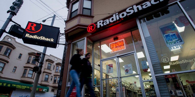 Pedestrians walk past a RadioShack Corp. store in San Francisco, California, U.S., on Saturday, June 7, 2014. RadioShack Corp. is expected to release earnings figures on June 10. Photographer: David Paul Morris/Bloomberg via Getty Images