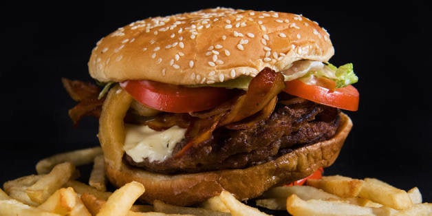 Burger King's 'Angry Triple Whopper' with three beef patties, bacon, pepper jack cheese, Jalapeno peppers, 'Angry' onions, tomatoes, lettuce and 'Angry' sauce is seen with their French Fries, August 19, 2009 in Washington, DC. It boasts 1360 calories, 91 grams of fat, 33 grams trans fat, 235 mg cholesterol, 59 grams of carbs, 13 grams sugar, 77 grams protein, and 1830 mg sodium not counting the French Fries. AFP Photo/Paul J. Richards (Photo credit should read PAUL J. RICHARDS/AFP/Getty Images)