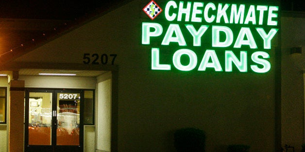 Neon signs illuminate a payday loan business in Phoenix on Tuesday, April 6, 2010, one of 650 operating in the state with some open 24-hours a day. A growing backlash against payday lending practices have prompted legislatures around the country to crack down on the businesses. (AP Photo/Ross D. Franklin)