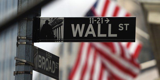 A Wall Street road sign is pictured near the New York Stock Exchange (NYSE) building on October 16, 2014 in New York. US stocks dropped sharply in early trade Thursday, following international markets downward as anxiety over global growth continued to prompt selling. About 30 minutes into trade, the Dow Jones Industrial Average stood at 16,062.34, down 79.40 points (0.49 percent). AFP PHOTO/Jewel Samad (Photo credit should read JEWEL SAMAD/AFP/Getty Images)