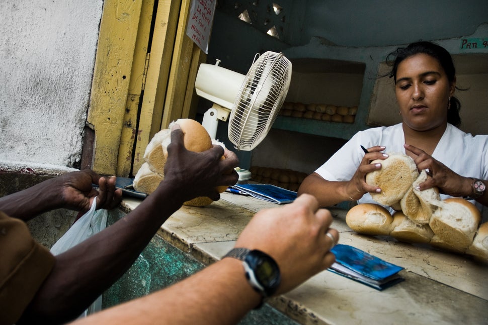 2008 - A young Cuban woman distributes a limited amount of bread to her fellow citizens according to quotas of the Cuban rati