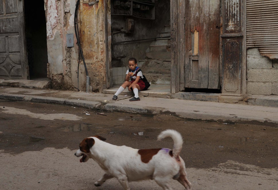 2009 - A Cuban schoolgirl sits at the foot of the entrance stairways in Havana.
